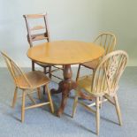 A pine circular breakfast table, 93cm diameter, together with four various chairs,