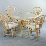 A bamboo circular glass topped conservatory table, together with four chairs,