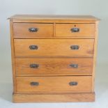 An Edwardian oak chest of drawers,