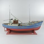 A painted wooden model of a fishing boat, 65cm long,