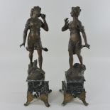 A pair of spelter figures, each on an onyx base,