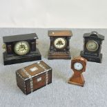 A 19th century black slate mantel clock, three others and a 19th century inlaid tea caddy,