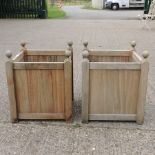 A pair of square teak garden planters, together with a pair of galvanised planters,