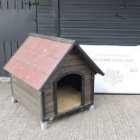 A wooden dog kennel, 90cm tall, together with another, unassembled,
