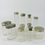 A collection of eleven silver mounted glass dressing table jars