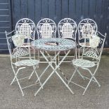 A green painted metal lattice folding table, 70cm diameter, with two matching chairs,