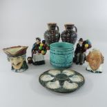 A Doulton Lambeth pottery jug, 20cm tall, together with another, two Royal Doulton balloon sellers,