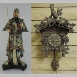 A cuckoo clock, 53cm tall, together with a Samurai figure,