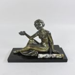 An Art Deco bronzed figure of a seated lady, on a black marble base,