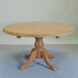 A pine circular dining table,