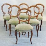 A set of six Victorian walnut balloon back dining chairs,