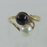 A 14 carat gold pearl, black pearl and diamond set ring,