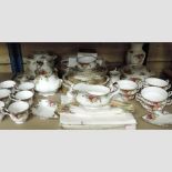 Two shelves of Royal Albert Old Country Roses pattern tea and dinner wares