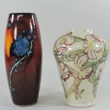 A modern Moorcroft vase, 22cm tall, together with a Poole style vase,