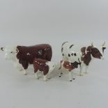 A Beswick model of a bull, with printed marks Ch Whitehill, 13cm tall, with calf,