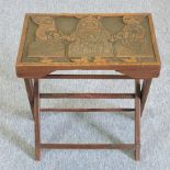 A mid 20th century African carved hardwood folding occasional table,