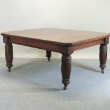 WITHDRAWN A Victorian mahogany wind-out extending dining table, on turned legs,