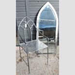 A metal gothic style armchair, together with a garden mirror,