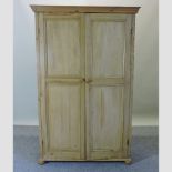 An antique pine double wardrobe, fitted with shelves,