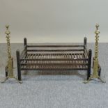 A black painted fire grate, together with a pair of fire dogs,