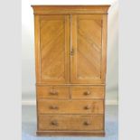 A Victorian ash linen press, on a plinth base,