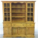 A modern pine dresser, with a glazed upper section,