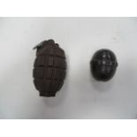 Two WW1 Inert Grenades consisting British Mills grenade No 23. Cast body. Steel base plug marked “