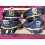 Four Various American Police Caps dark blue crown with lower black band. Black patent peaks. Various