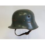 WW1 1917 Pattern German Steel Helmet green painted crown of typical form with lower rolled brim.