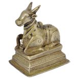 A BRASS FIGURE OF NANDI BULL, WESTERN DECCAN, INDIA, CIRCA 18TH CENTURY on a raised rectangular base