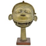 A BRASS STANDARD FINIAL, WESTERN DECCAN, 19TH CENTURY in the form of a head of Hanuman, with