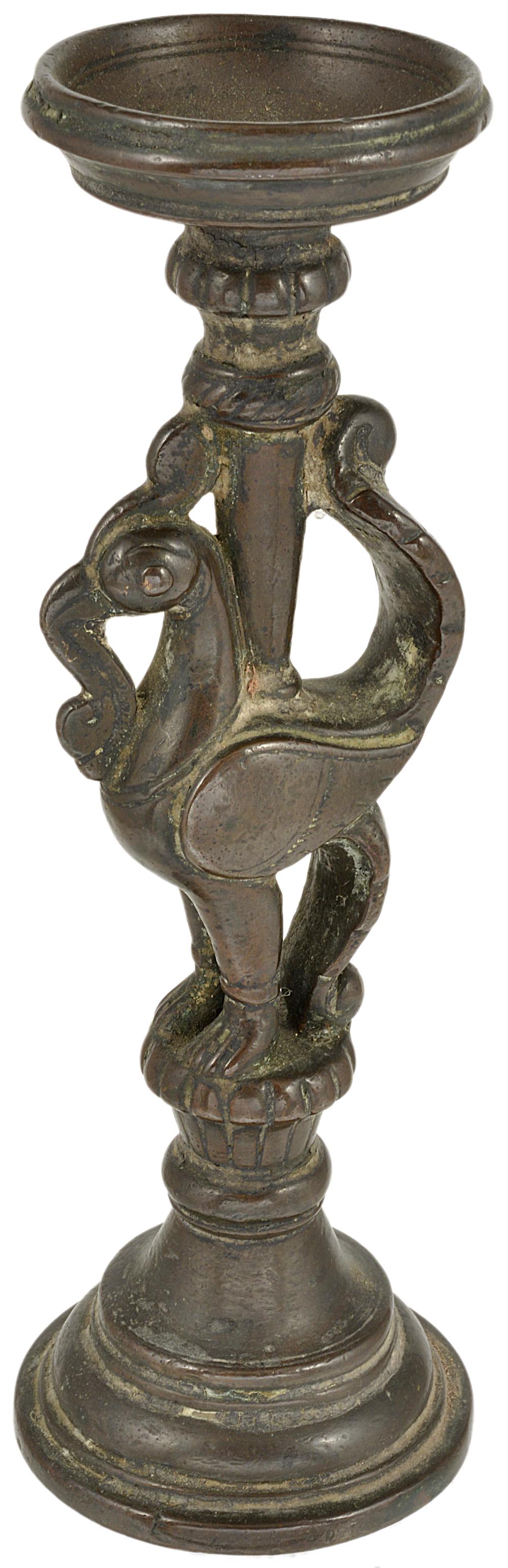 A BRONZE LAMP STAND, SOUTHERN INDIA, 18TH CENTURY in the form of a hamsa perched on a raised