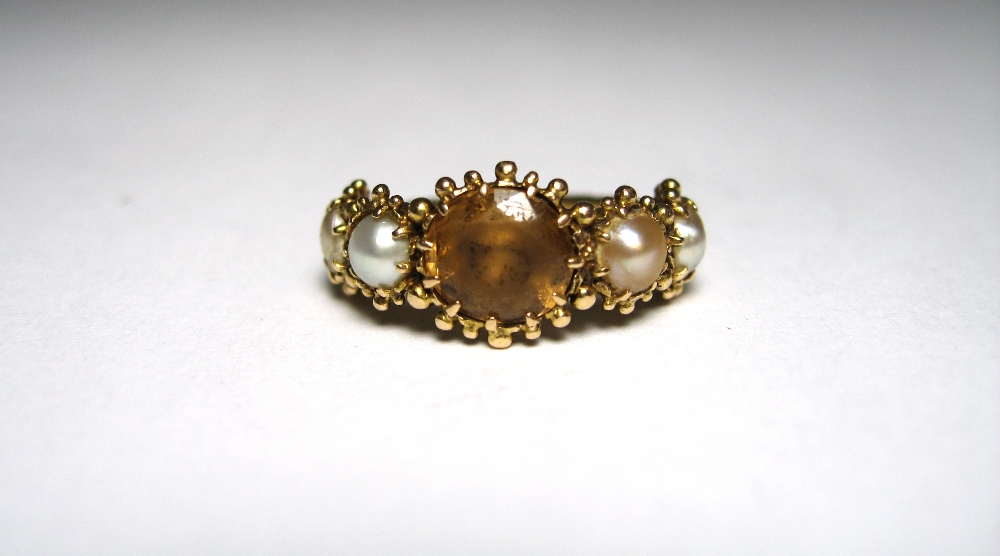 CITRINE AND PEARL RING, EARLY 19TH CENTURY the oval citrine in a closed back setting mounted between - Image 2 of 4