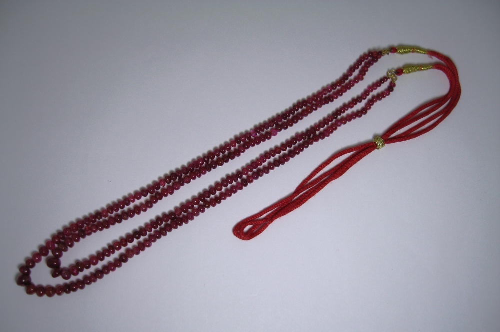 RUBY NECKLACE designed as two graduated rows of polished ruby beads on an adjustable cord - Image 2 of 3