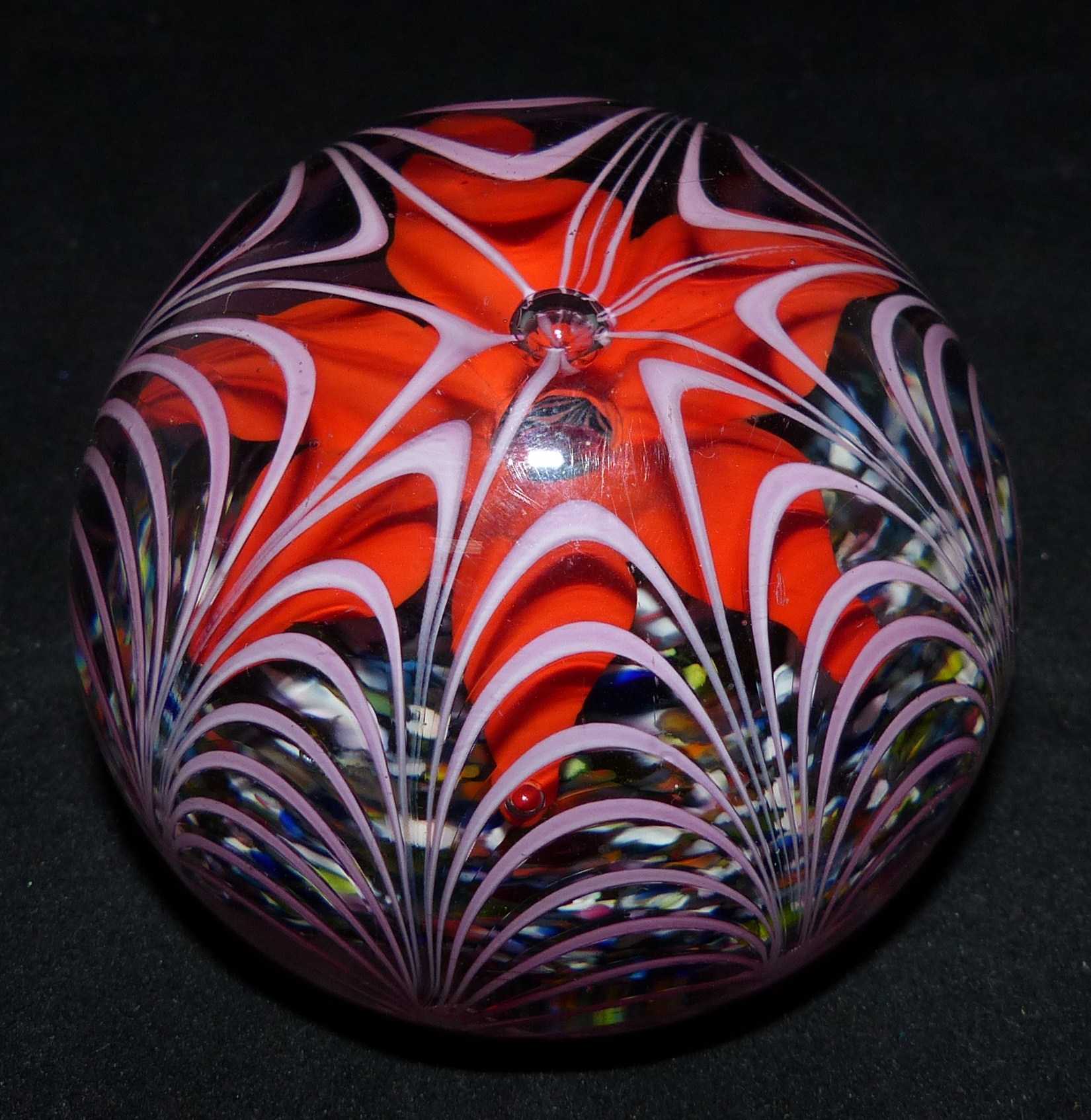A 19th century glass paperweight with red 6 petal flower on multicolour ground with drawn