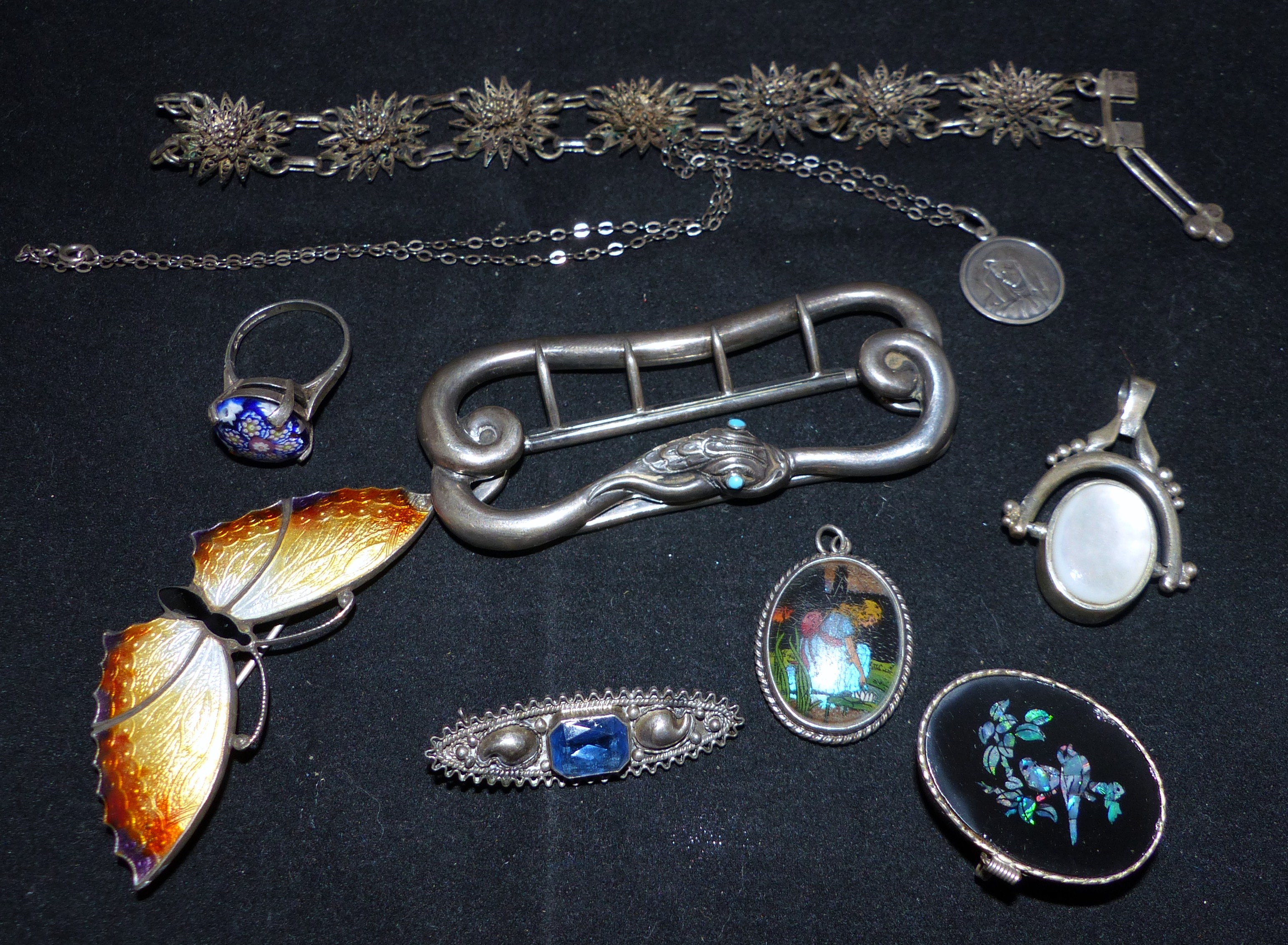 A 19th century snake belt buckle set with turquoise eyes; a silver and enamel butterfly brooch;