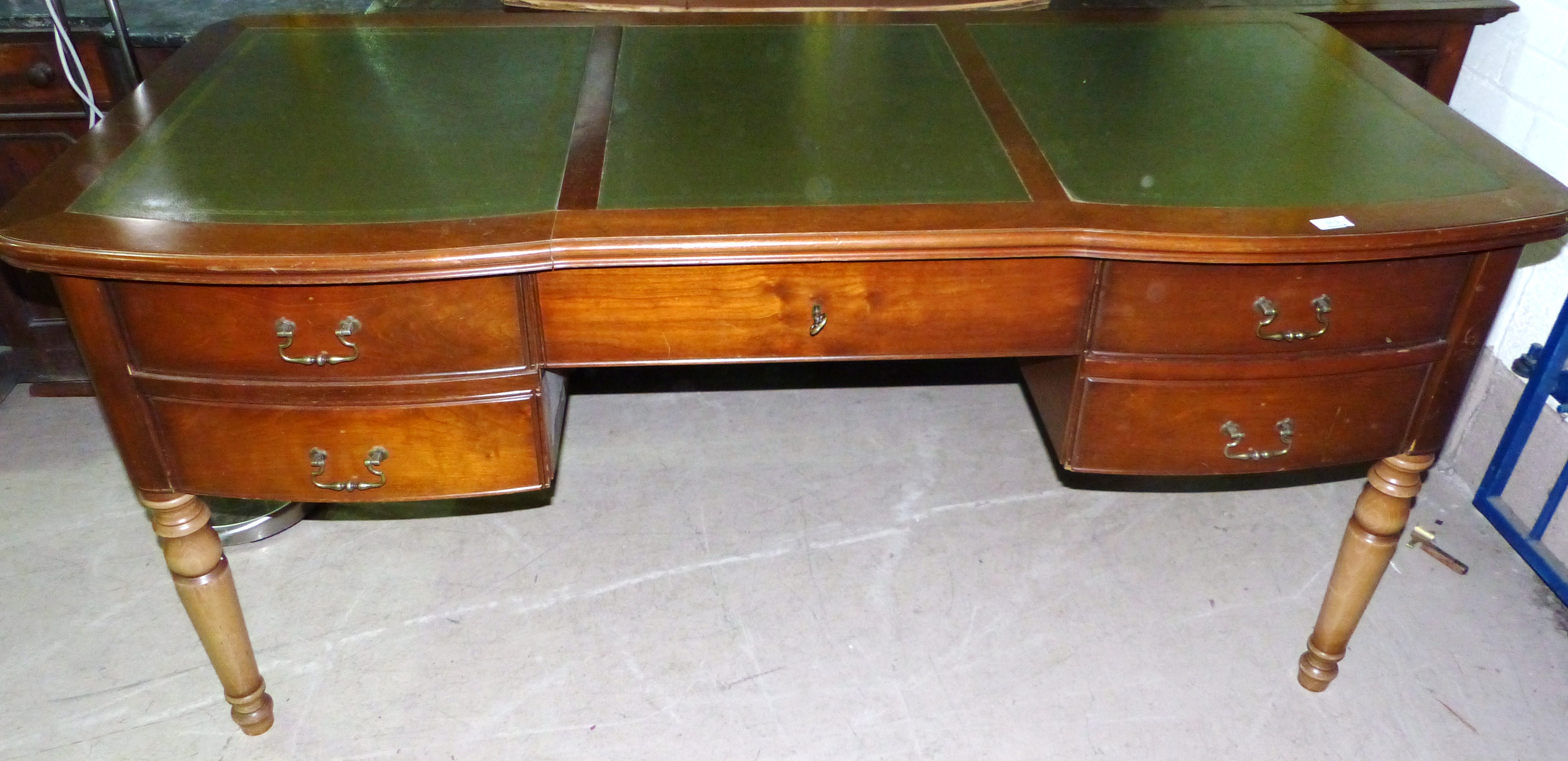 A Georgian style kneehole desk with inset leather top, double drawer and filing drawer to each side