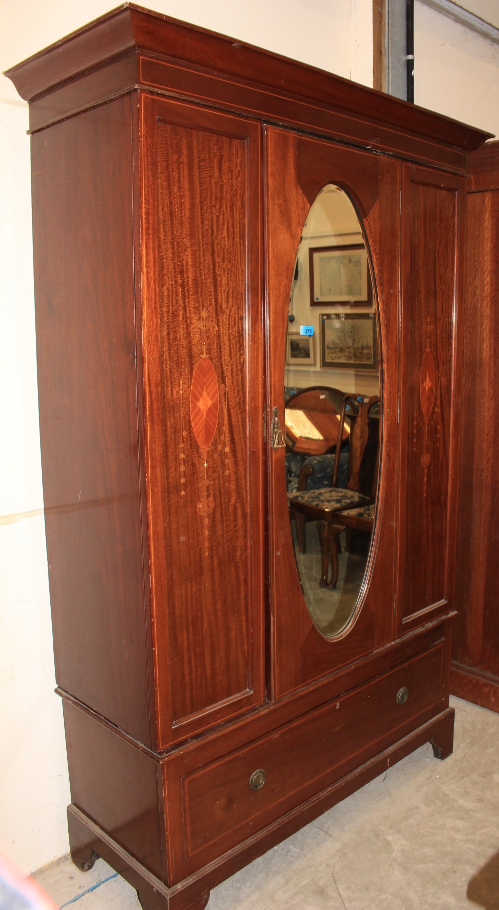 An Edward VII mahogany inlaid wardrobe with mirror door over base drawer. 46" wide