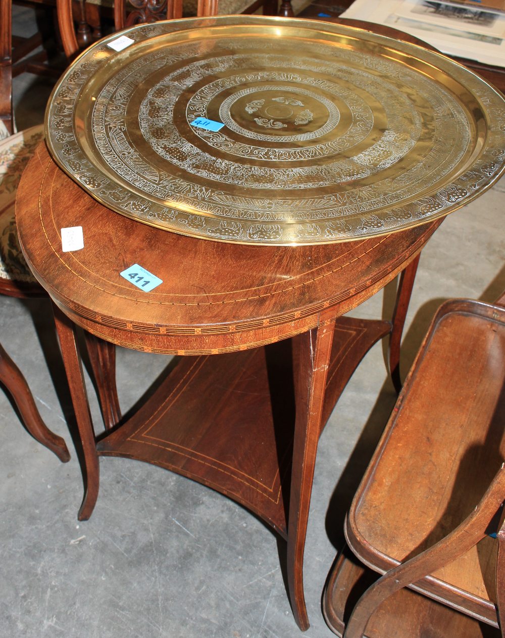 An Edward VII mahogany line inlaid oval centre table and a brass benares tray