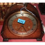 An oak case mantle clock