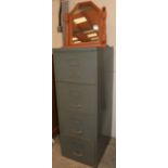 A metal filing cabinet and a dressing mirror