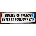 A metal Beware of the Dog plaque