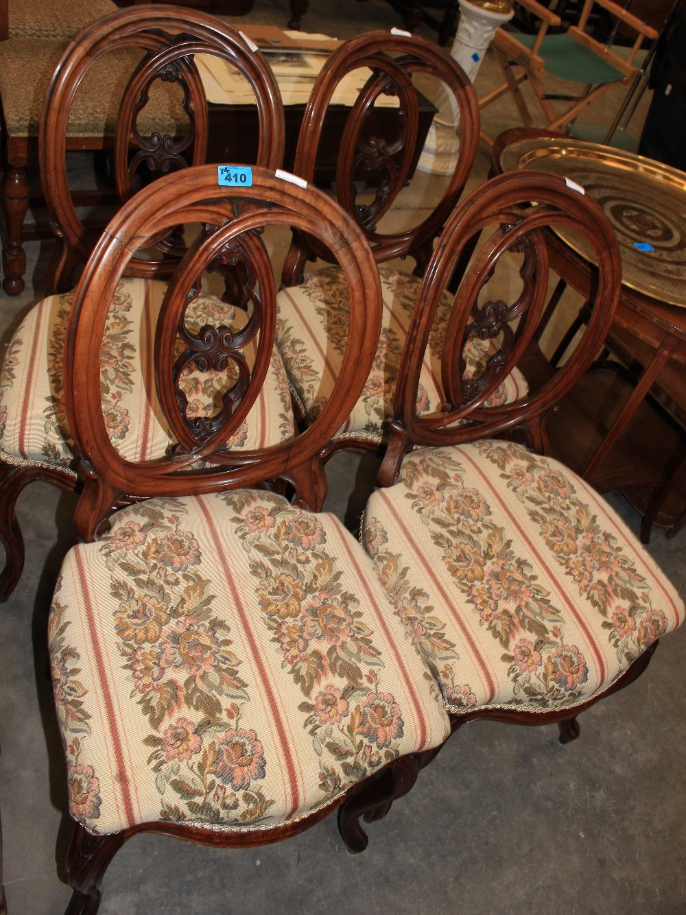 A set of four Victorian walnut dining chairs with open interlaced balloon backs and serpentine