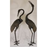 A pair of Japanese bronze models of cranes, the taller 55" high. 20th Century