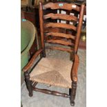 A 19th Century country ladderback chair with rush seat on pad feet