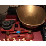 A set of cast iron kitchen scales with brass pan and weights to weigh 28lb. Early 20th Century