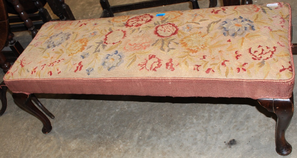 A long stool with tapestry top on cabriole legs. 45" wide