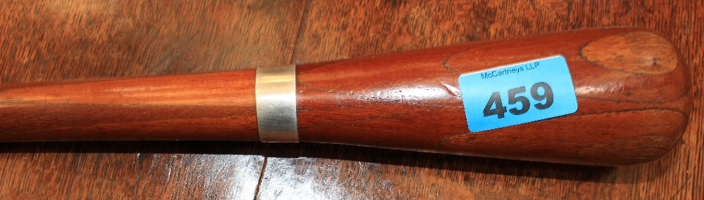 A walking cane with inlaid pommel and white metal collar