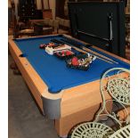 A pool table with balls and cues together with a table tennis table