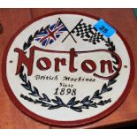 A metal Bibendum on bicycle figure and a 'Norton' metal plaque